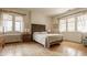 Bright and spacious bedroom with large windows, hardwood floors, and a comfortable bed at 3840 N Washington Blvd, Indianapolis, IN 46205