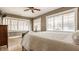 This bedroom features hardwood floors, ceiling fan, and three large windows allowing ample natural light at 3840 N Washington Blvd, Indianapolis, IN 46205