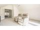 Bonus room featuring neutral carpet, two reclining chairs, and glass french doors leading to a bedroom at 3840 N Washington Blvd, Indianapolis, IN 46205