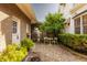 Charming courtyard with gravel, a small table, and lush greenery, creating a peaceful outdoor space at 3840 N Washington Blvd, Indianapolis, IN 46205