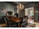 Beautiful dining room with a chandelier, dark walls, and hardwood floors. Open concept at 3840 N Washington Blvd, Indianapolis, IN 46205