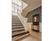 The beautiful foyer features a wood staircase, wainscoting, and wood floors at 3840 N Washington Blvd, Indianapolis, IN 46205