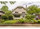 Charming two-story home with brick facade, awning-covered windows, and a well-manicured front lawn at 3840 N Washington Blvd, Indianapolis, IN 46205