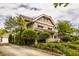 Beautiful two-story home featuring a brick facade, mature trees, and a well-maintained lawn at 3840 N Washington Blvd, Indianapolis, IN 46205