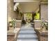 Covered front porch with brick columns, flowers, checkerboard flags, and comfortable seating at 3840 N Washington Blvd, Indianapolis, IN 46205