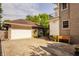 Spacious garage adjacent to the home, complemented by lush landscaping and a well-maintained exterior at 3840 N Washington Blvd, Indianapolis, IN 46205