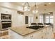 Bright eat-in kitchen features a center island, granite countertops, custom white cabinets and stainless steel appliances at 3840 N Washington Blvd, Indianapolis, IN 46205