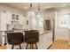 Bright eat-in kitchen features a center island, granite countertops, stainless steel appliances, and bar stool seating at 3840 N Washington Blvd, Indianapolis, IN 46205