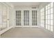 Light-filled room with multiple french doors and carpet at 3840 N Washington Blvd, Indianapolis, IN 46205