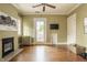 Spacious living room with hardwood floors, a fireplace, and a door to the outside at 3840 N Washington Blvd, Indianapolis, IN 46205