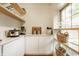 This beautiful pantry features custom shelving and white cabinets at 3840 N Washington Blvd, Indianapolis, IN 46205