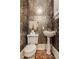 This powder room features custom wallpaper, a stylish vanity sink, and new fixtures at 3840 N Washington Blvd, Indianapolis, IN 46205