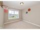 An unfurnished bedroom with carpeted floors, a basketball hoop, and a large window at 4061 Secretariat Ln, Bargersville, IN 46106