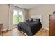 Bedroom featuring a queen bed with a dark patterned comforter and a window overlooking the lawn at 4061 Secretariat Ln, Bargersville, IN 46106