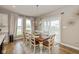 Dining room with a wooden table, seating for eight, and large windows offering natural light at 4061 Secretariat Ln, Bargersville, IN 46106