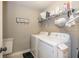 Functional laundry room with washer, dryer, and ample storage at 4061 Secretariat Ln, Bargersville, IN 46106