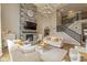 Spacious living room featuring a stone fireplace, two-story ceiling, and staircase access at 4061 Secretariat Ln, Bargersville, IN 46106