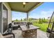 Relaxing covered patio featuring a cozy seating area, stylish rug, and a fire pit table for cool evenings at 4061 Secretariat Ln, Bargersville, IN 46106