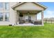 Inviting covered patio with string lights, comfortable seating, and a mounted TV, perfect for outdoor entertaining at 4061 Secretariat Ln, Bargersville, IN 46106