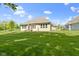 Spacious backyard featuring a lush lawn and partial view of the home's exterior at 4125 Sugar Pine Ln, Zionsville, IN 46077