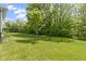 Expansive backyard featuring lush green grass and mature trees providing shade at 4125 Sugar Pine Ln, Zionsville, IN 46077
