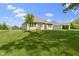 Lush green backyard with a well-maintained lawn and view of the home's exterior at 4125 Sugar Pine Ln, Zionsville, IN 46077