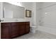 Bathroom with a dark wood vanity, a large mirror, and a shower/tub combo at 4125 Sugar Pine Ln, Zionsville, IN 46077