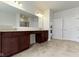 Bathroom featuring a double vanity with a long mirror and a shower room beyond at 4125 Sugar Pine Ln, Zionsville, IN 46077