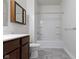 Bathroom featuring a dark wood cabinet, white toilet and a tub/shower combo at 4125 Sugar Pine Ln, Zionsville, IN 46077