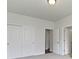 Bright bedroom with closet, multiple doors, and neutral-toned carpeting at 4125 Sugar Pine Ln, Zionsville, IN 46077