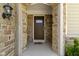 Inviting front door framed by stone archway and complementary sidelights at 4125 Sugar Pine Ln, Zionsville, IN 46077