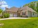 Beautiful home featuring a two-car garage, stone accents, and lush green lawn at 4125 Sugar Pine Ln, Zionsville, IN 46077