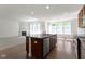 Open-concept kitchen with island overlooking the living room with a fireplace at 4125 Sugar Pine Ln, Zionsville, IN 46077