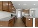Spacious kitchen with stainless appliances, granite countertops, island, and brown wooden floors at 4125 Sugar Pine Ln, Zionsville, IN 46077