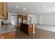 Bright open-concept kitchen featuring a large island, granite countertops, wood cabinetry, and stainless steel appliances at 4125 Sugar Pine Ln, Zionsville, IN 46077