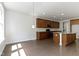 A view of the kitchen showcasing wood cabinets, granite countertops, and stainless steel appliances on a wooden floor at 4125 Sugar Pine Ln, Zionsville, IN 46077