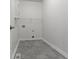 Bright laundry room features gray flooring, wire shelving and cabinet storage at 4125 Sugar Pine Ln, Zionsville, IN 46077