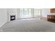 An open living room with a fireplace, carpet, and lots of windows at 4125 Sugar Pine Ln, Zionsville, IN 46077