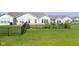 Green backyard featuring a well-maintained lawn and a black metal fence at 4181 Gordman Dr, Whitestown, IN 46075