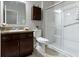 Bathroom featuring a walk-in shower with glass doors, dark cabinets, and a matching vanity at 4181 Gordman Dr, Whitestown, IN 46075