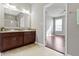 Bright bathroom featuring a double sink vanity and an open doorway to another room at 4181 Gordman Dr, Whitestown, IN 46075