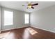Bedroom featuring hardwood floors, neutral walls, two windows, and ceiling fan at 4181 Gordman Dr, Whitestown, IN 46075
