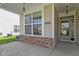 Charming front porch featuring brick accents, a large window, and a welcoming entrance to the home at 4181 Gordman Dr, Whitestown, IN 46075