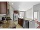 Open kitchen featuring granite countertops, an island with sink, stainless dishwasher, and dark brown cabinets at 4181 Gordman Dr, Whitestown, IN 46075