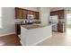 Open kitchen featuring granite countertops, a large island, stainless appliances, and dark brown cabinets at 4181 Gordman Dr, Whitestown, IN 46075
