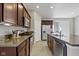 Bright kitchen with stainless steel appliances, granite countertops, and dark brown cabinetry at 4181 Gordman Dr, Whitestown, IN 46075