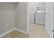 Neutral laundry room area with tile floors and white washer and dryer at 4181 Gordman Dr, Whitestown, IN 46075