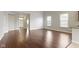 Open-concept living room with hardwood floors and ample natural light, creating a warm and inviting atmosphere at 4181 Gordman Dr, Whitestown, IN 46075