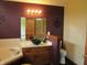 Bathroom featuring a black vessel sink, wooden vanity, and jacuzzi tub at 4288 Silver Hill Dr, Greenwood, IN 46142