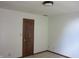 A simple room with neutral carpet and a wooden door at 4288 Silver Hill Dr, Greenwood, IN 46142